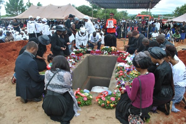 Rose Chibambo's grandchildren praying after laying wreaths during the burial of their grand mother-Pix By Joel Chirwa( Mana)