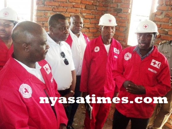 Roster Kufandiko (far right) speaking to government officials