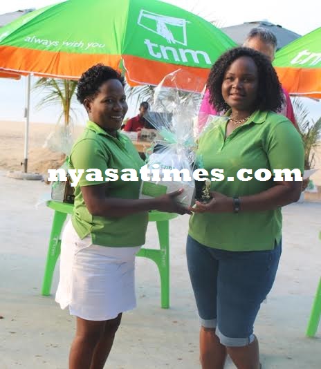 Roza Mbilizi receive her prize from TNM official  Stella Hara (in white skirt).