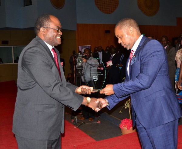 Vice President Dr  Saulos Chilima, presents award trophy to President of Malawi Institute of Procurement and Supply, Mr. Edington Chilapondwa at BICC in Lilongwe-(c) Abel Ikiloni, Mana