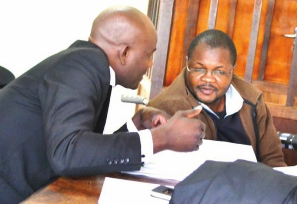  Lutepo speaks with his lawyer Oswald Mtupila at High Court in Zomba 