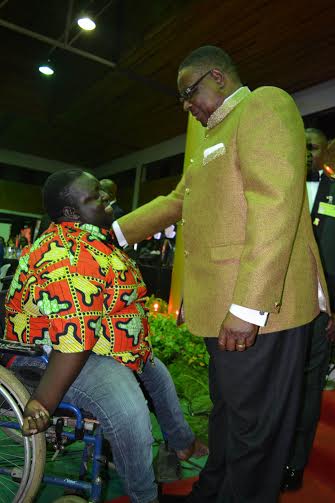 President Mutharika congratulates Sautso Ndalama, who won the disability award