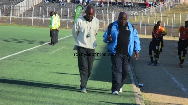 Silver Strikers coach Stain Chirwa (rights) sharing notes with his colleague on the way to the dressing room on half time....Photo Jeromy Kadewere.