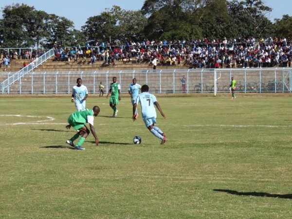 Silver's Ian Banda tries to beat a Mzuni player, Pic Alex Mwazalumo