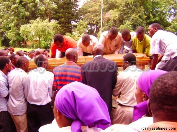 Some of the football officials helping to carry the casket into a car ___Photo Jeromy Kadewere