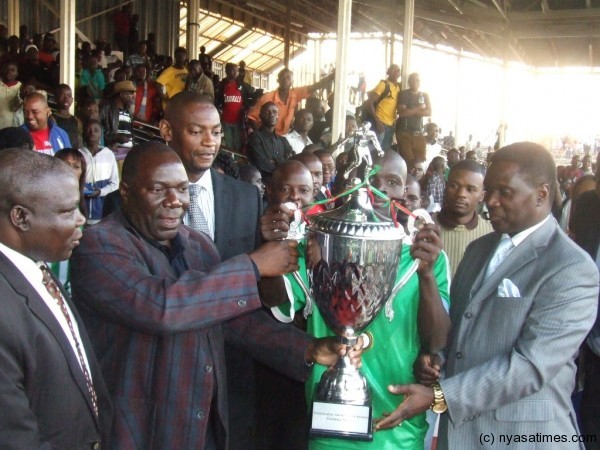 Sports Minister Chihana left presenting the trophy to Mafco Captain  Photo by Elijah Phimbi, Nyasa Times