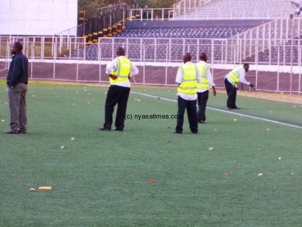 Stewarts trying to clear the pitch at Kamuzu Stadium...Photo Jeromy Kadewere