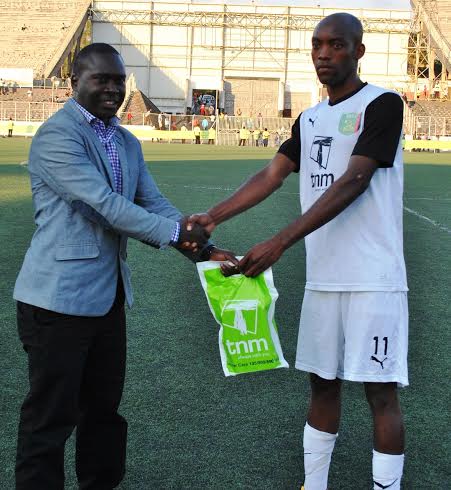 Sulom's Tiya Somba Band hands over man of the match accoldate to Mkacha.-Photo Jeromy Kadewere.