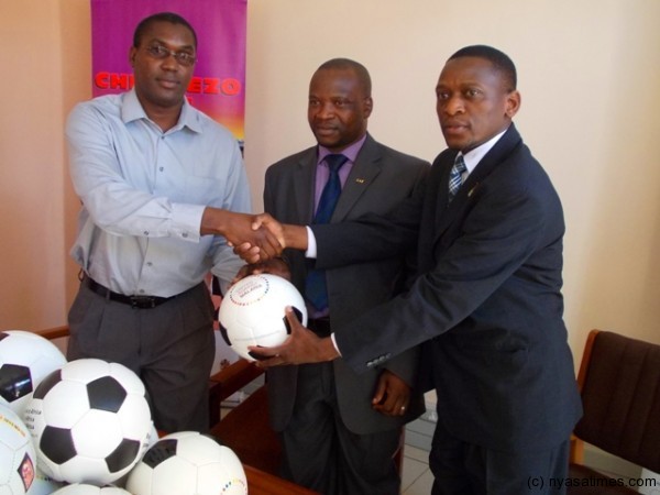 Yuma (R) presents the balls to Nyirenda (C) and Lungu.-Photo by Jeromy Kadewere, Nyasa Times