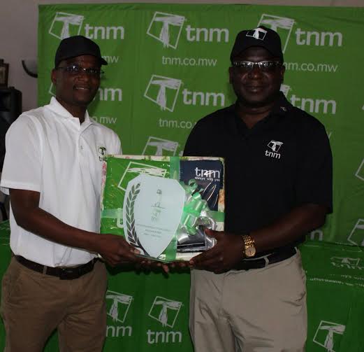 TNM Chief Commercial Officer Daniel Makata (left) presenting the prizes and trophies to Mukiwa