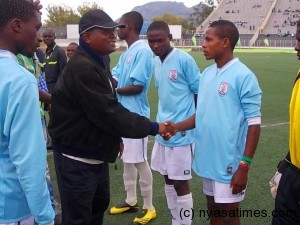 TNM Official Willy Phalula shaking Mada Chuma's for Mzuzu United...Photo Jeromy Kadewere