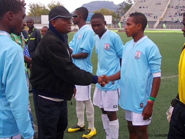 TNM Official Willy Phalula shaking Mada Chuma's for Mzuzu United...Photo Jeromy Kadewere