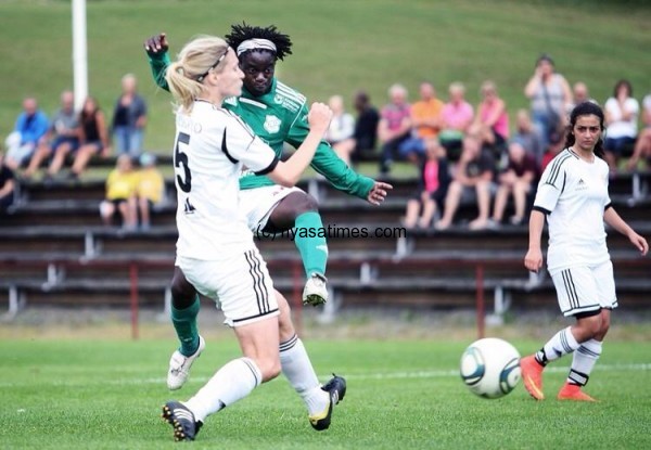 Tabitha chawinga (in green) in action