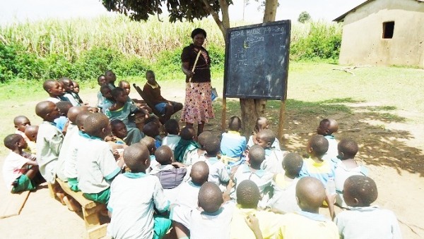 Teaching pupils under a tree which is used as their class