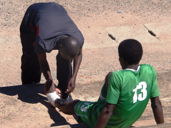 Team-Doctor-Levison-Mwale-assisting-injured-Yamikani-Fodya...Photo-Jeromy-Kadewere