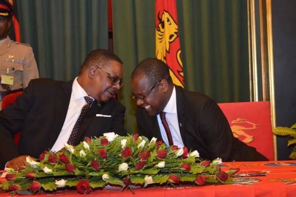 Tembenu (right) with President Mutharika: Clarifies that President can delegate on answering questions