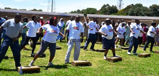 The Chief Secretary to the Govt. Mr. George Mkondiwa in cream trouser among the group of Aerobics participants at Civo Stadium in Lilongwe-Pic. by Abel Ikiloni