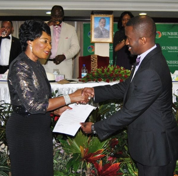 The First Lady Madam Dr. Getrude Mutharika present an air ticket to the  winner after an auction during the event - Pic Mayamiko Wallace - MANA