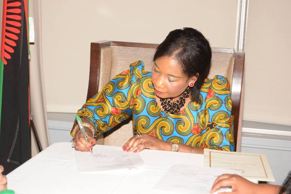 The First Lady Madam Getrude Mutharika signing an agreement for the grant