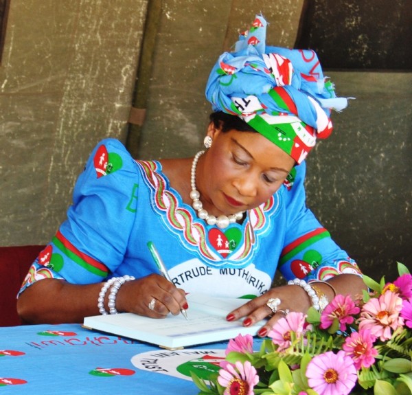 The First Lady signing the visitors book at Samama primary school during the tree planting exercise in Mangochi- pic Mayamiko Wallace