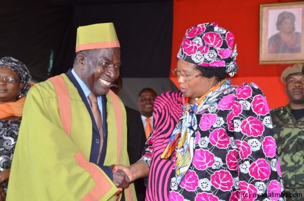 The President greets MP for the area and Information Minister Moses Kunkuyu at the venue of the Development Rally at Nancholi on Friday