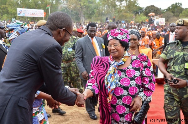 The President greets MP for the area and Information Minister Moses Kunkuyu at the venue of the Development Rally at Nancholi on Friday