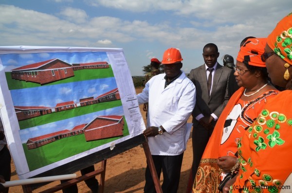 The President is taken through a graphic illustration of the Health Centre