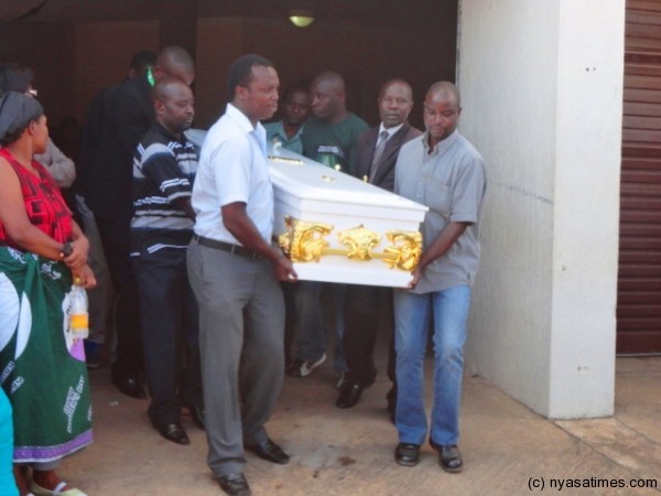 The casket being taken out from the mortuary....Photo by Jeromy Kadewere