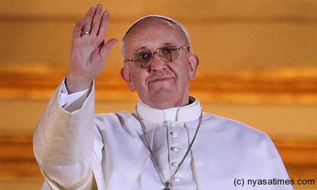 Pope Francis blesses the crowd from St Peter's Basilica at the Vatican.