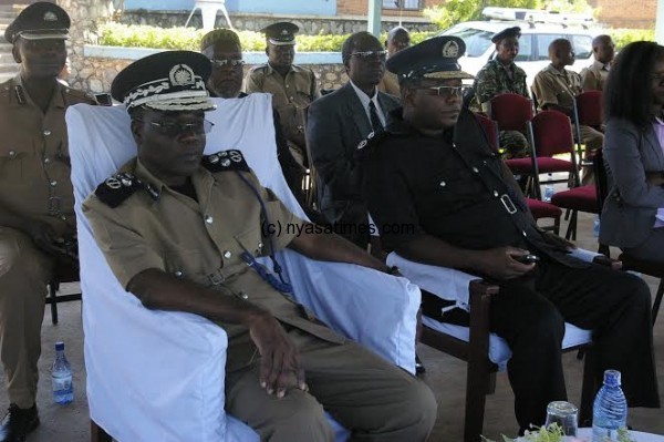 The police IG (L) watch the proceedings during the event.