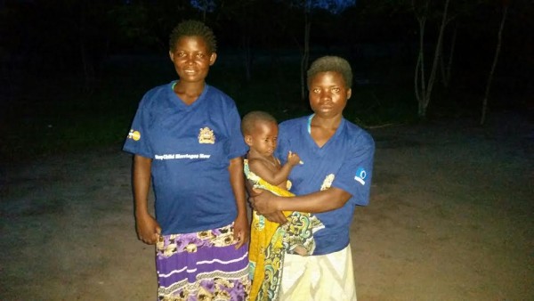 The two girls in blue shirt one carrying baby is Manes Mating,  a member carrying her baby while . The one pregnant is Yasinta she's the vice chairperson of the group.