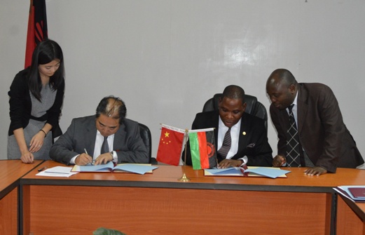 Trade and Industry MinisterJoseph Mwanamvekha and the Chinese Ambassador to MalawiH.E.Mr.Zhang Qingyang signs the Memorandum of Understanding - Pic by Stanley Makuti