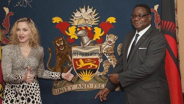 US pop star Madonna poses with Malawi's president Peter Mutharika prior to their meeting at Kamuzu Palace in the Capital Lilongwe, on Nov 28, 2014.