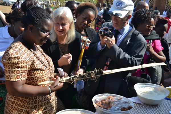USAID Chief of party, Marie Cadrin being shown the mouse at the display of food at TA Kalumbu in Lilongwe-(c) Abel Ikiloni, Mana