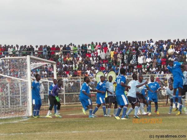Under siege, a Wanderers defender tries to clear am aerial ball.-Photo By Leonard Sharra, Nyasa Times