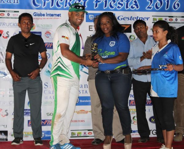 Unyolo (R) presenting a trophy to one of individual category winners