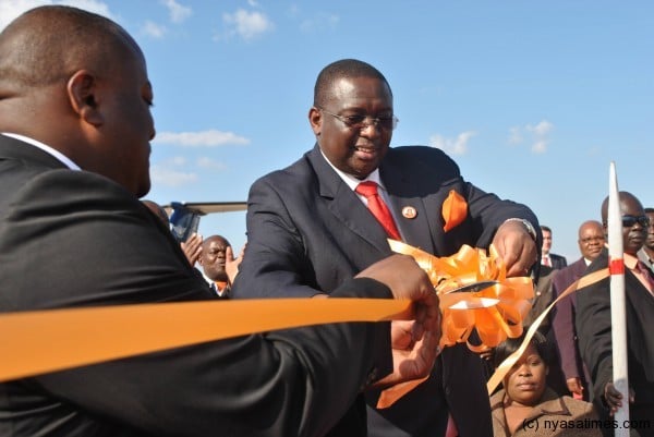 VP Khumbo Kachali cuts a ribbon to officially inaugurate the helicopter - geophysical survey at Chileka airport on Monday