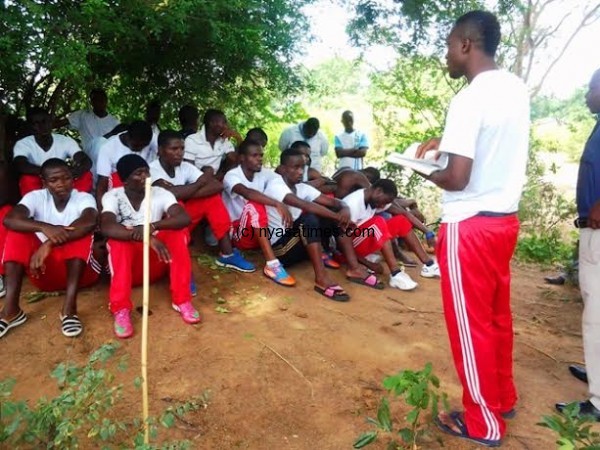 Victor Limbani preaching the word of God to his fellow players at Chinkhwawa boma on a stop over to their game.....Photo Jeromy Kadewere