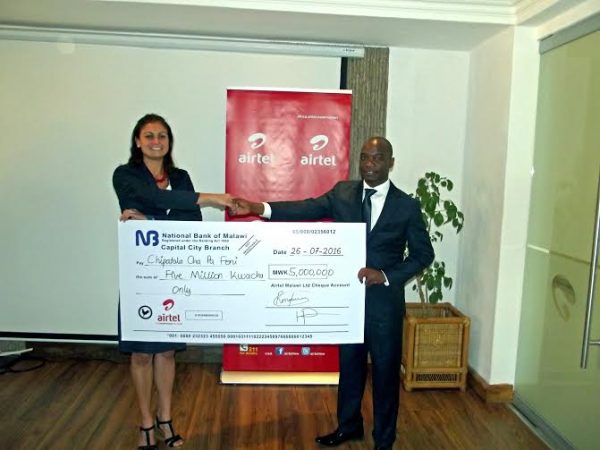 Village Reach Country Director Carla Blauvelt with Airtel MD Charles Kamoto