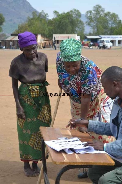 Voters being assisted by electoral official