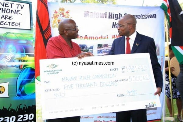 Wananchi Group boss presents a cheque to Brig. Marcel Chirwa