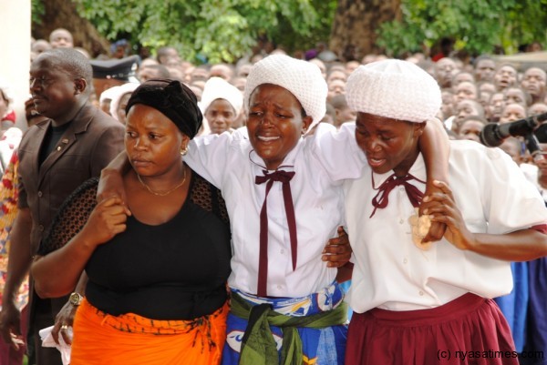 Wife of the departed Senior Chief being consoled by fellow Chuerch members