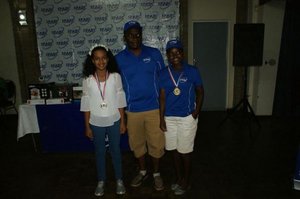 Wisely Phiri (centre) poses with the junior golf champions Zita Rodrick and Quasaira Lambat