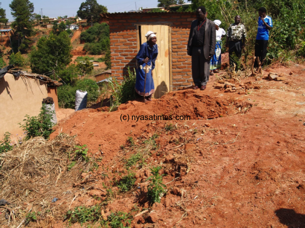 Working towards improved sanitation in a Mzuzu high density neighborhoods. New composting toilet is seen in the background