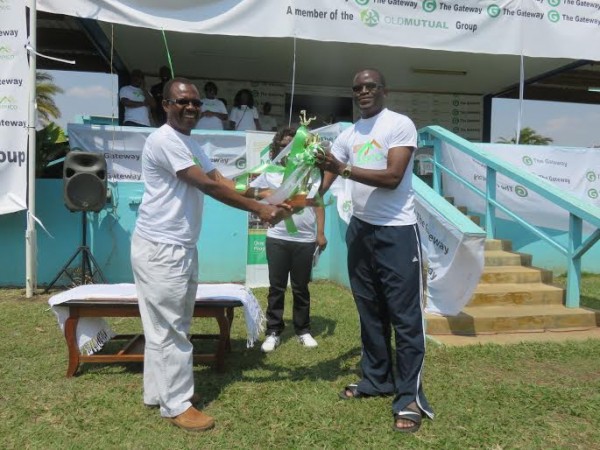 Yobe (black bottom) receiving the cup from Mpico during the launch