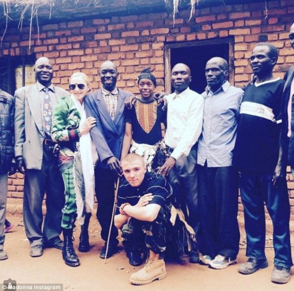 Yohane, seen here, third left, posing with David, middle, Madonna, Rocco, crouching, and village elders during the visit to Yohane's home last Friday Read more: http://www.dailymail.co.uk/news/article-3686375/I-healed-rift-Madonna-Malawian-father-star-s-adopted-son-reveals-happy-heartache-Rocco-custody-battle.html#ixzz4ELwe2SI4 Follow us: @MailOnline on Twitter | DailyMail on Facebook