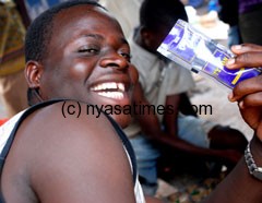 Young man enjoying liquor  satchet