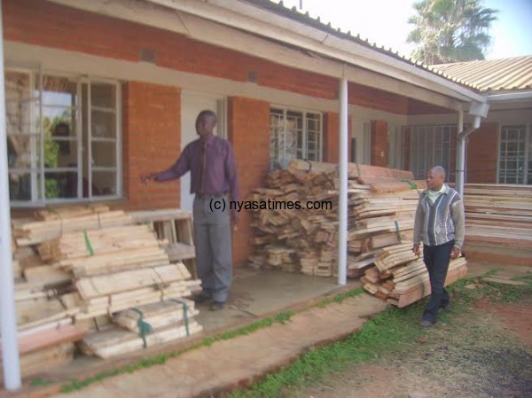 Zangazanga (L) points at the confiscated timber.