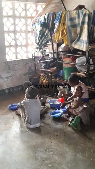 A displced family in a classroom in Bangula