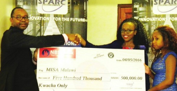 Mambulasa received the  donation from Chiwaya as Elsie Bakali looks on